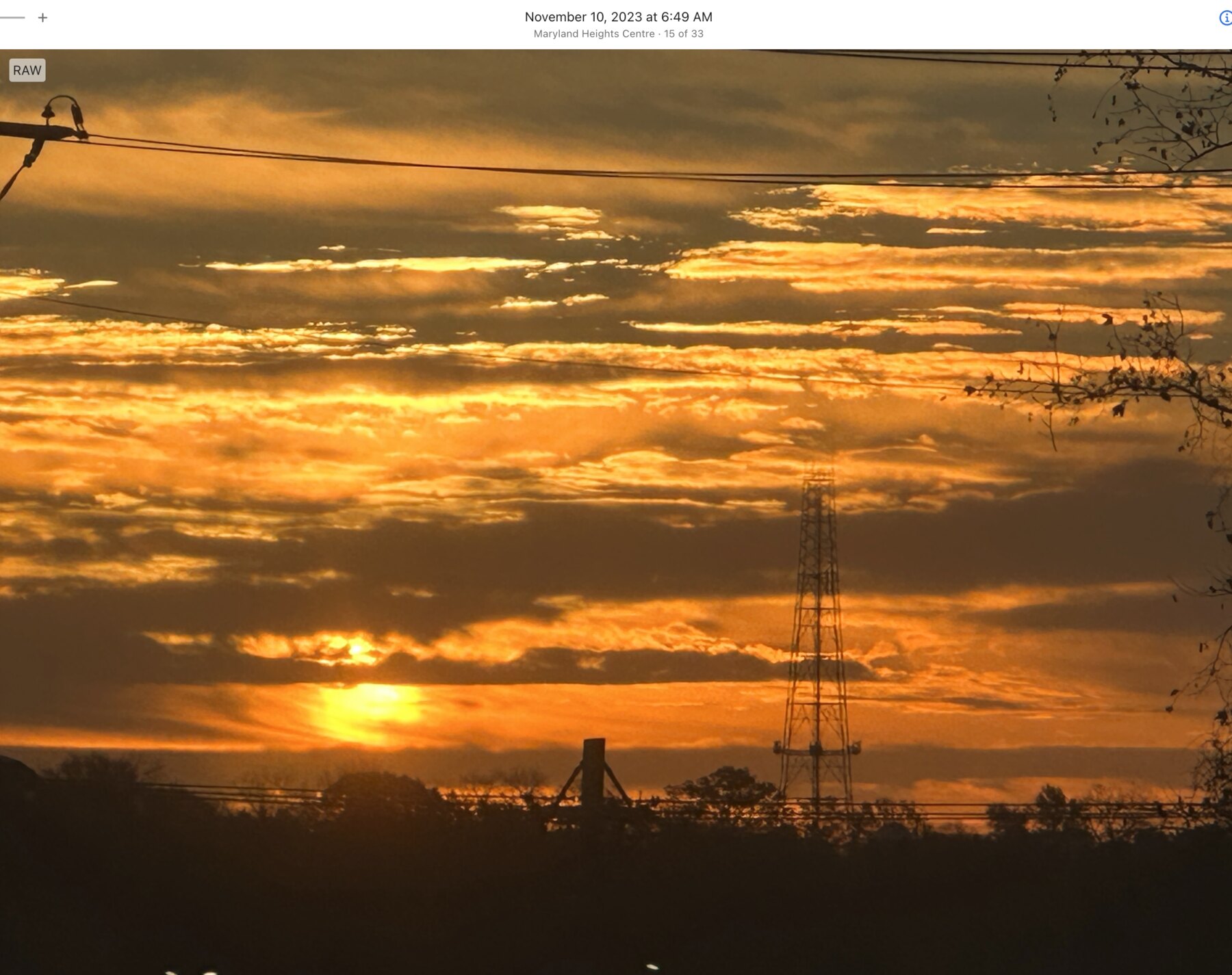 Layered gold clouds above the Maryland Heights horizon