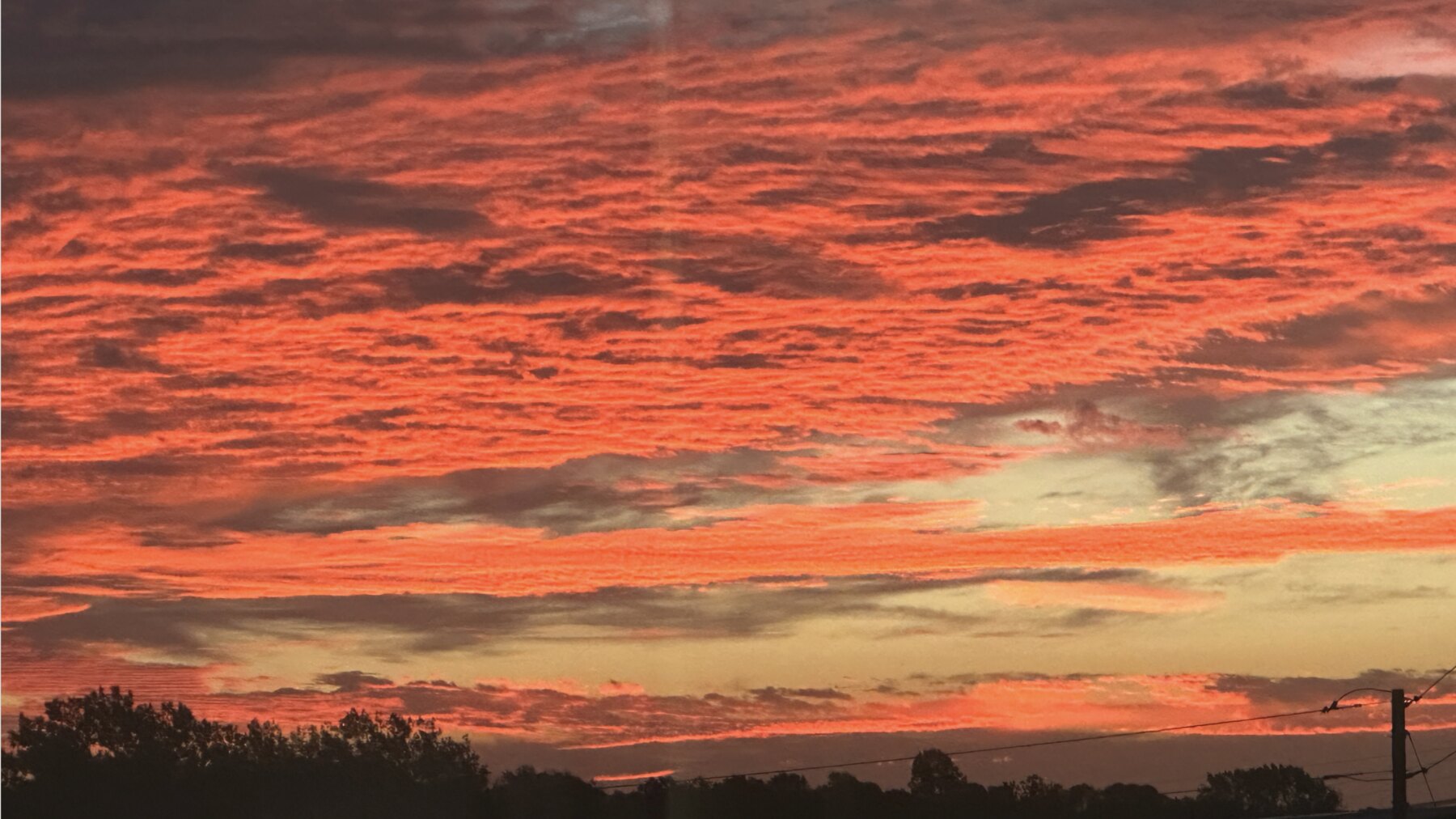 Brilliant red sunrise clouds stretched across the horizon
