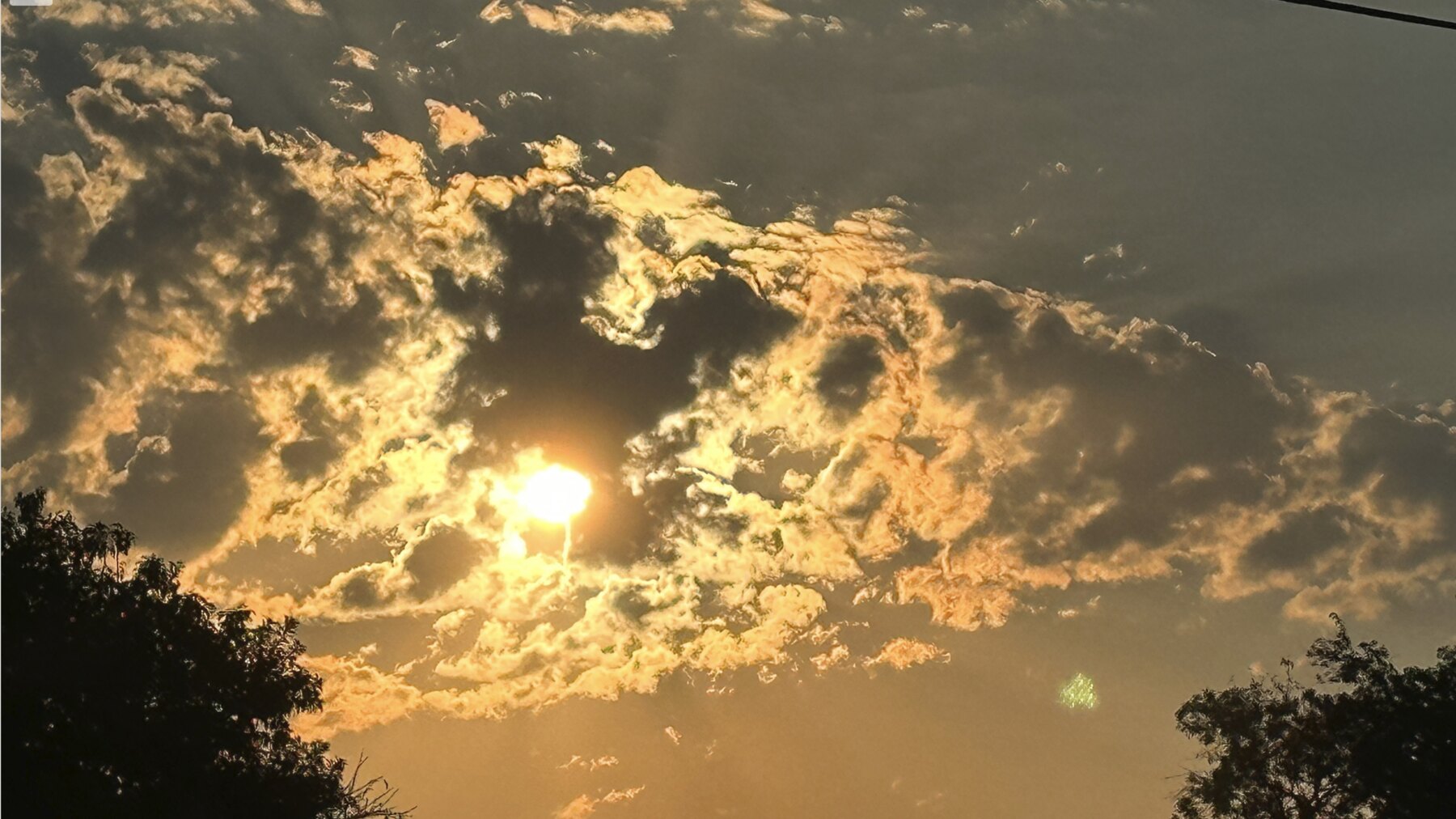 Sun glowing through textured gold clouds