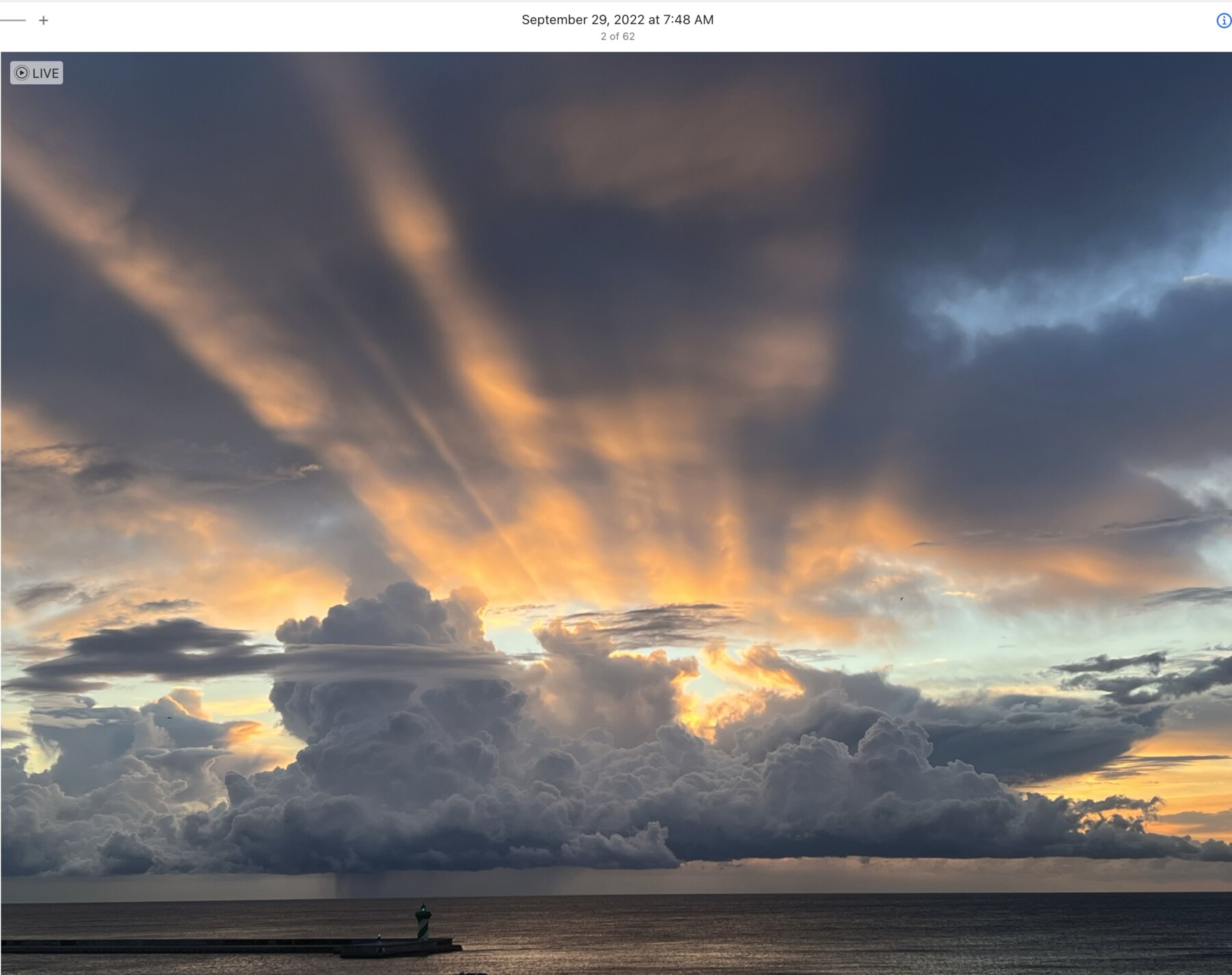 Dramatic Barcelona sunrise with golden rays above the sea