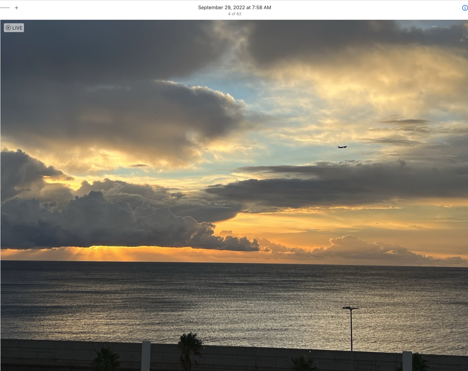 Sunrise opening beneath layered clouds above the Mediterranean